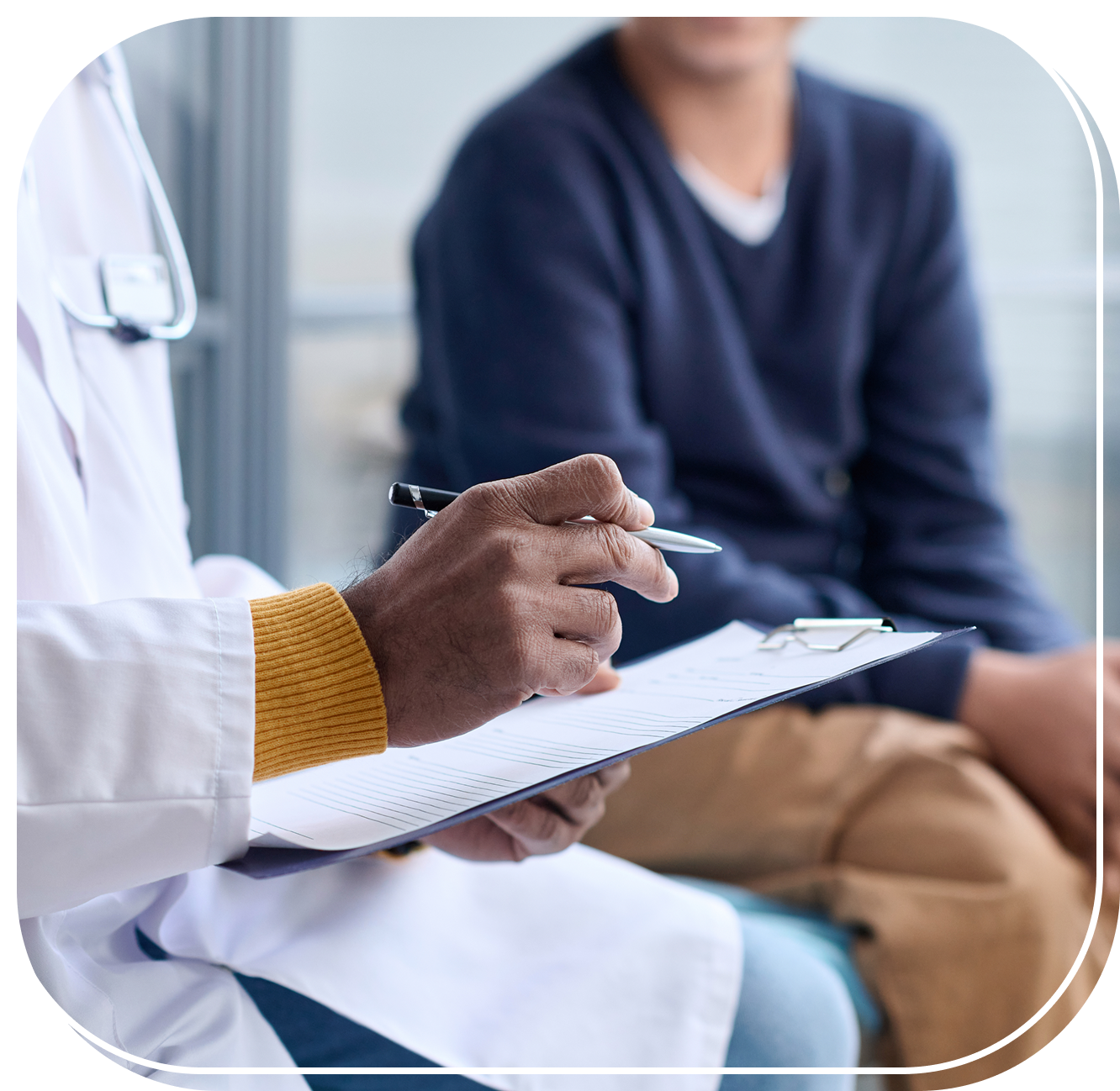 Group 1 (3) Doctor writing notes during patient consultation.