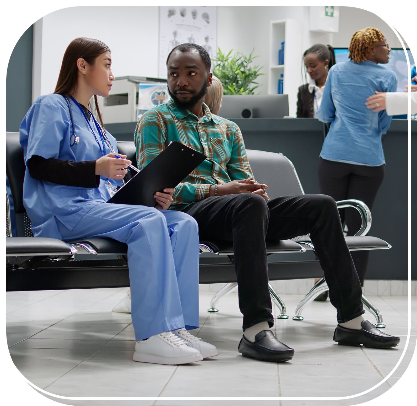 Group 1 (5) Nurse and patient talking in hospital waiting area.